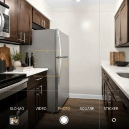 kitchen with ample counter-space, modern appliances and bright lighting