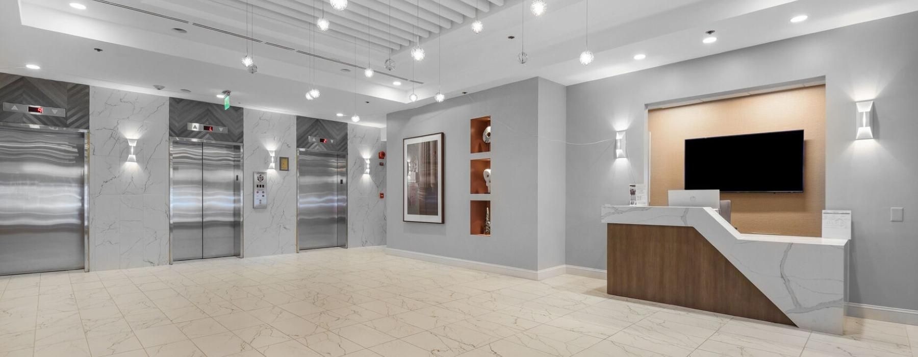bright elevator lobby with concierge desk